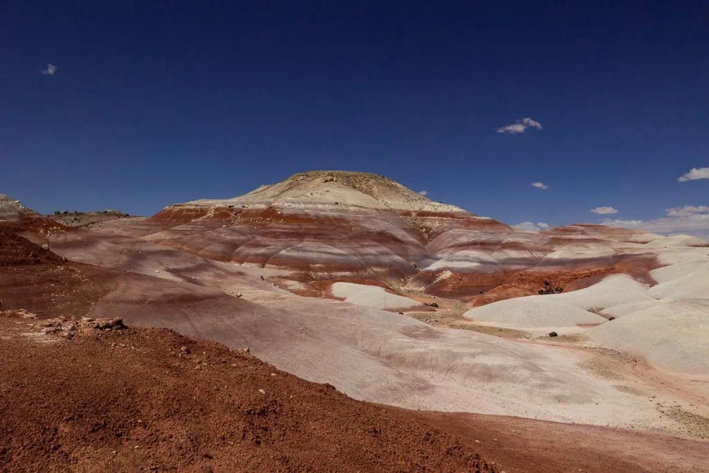 The bentonite hills are layered with red, purple, grey and white gravel.