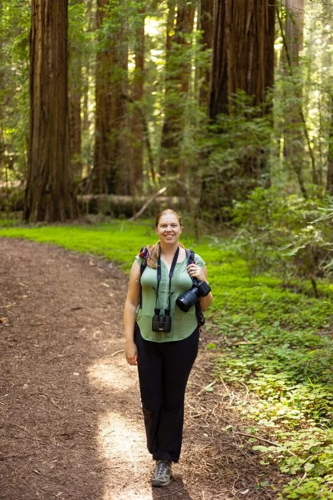 Lucy, a Redwoods elopement photographer, is seen in the forest.