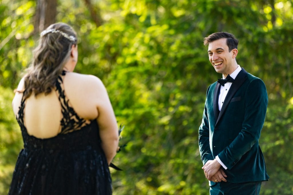 Yosemite elopement photos of a first look between a groom and bride in a black dress.