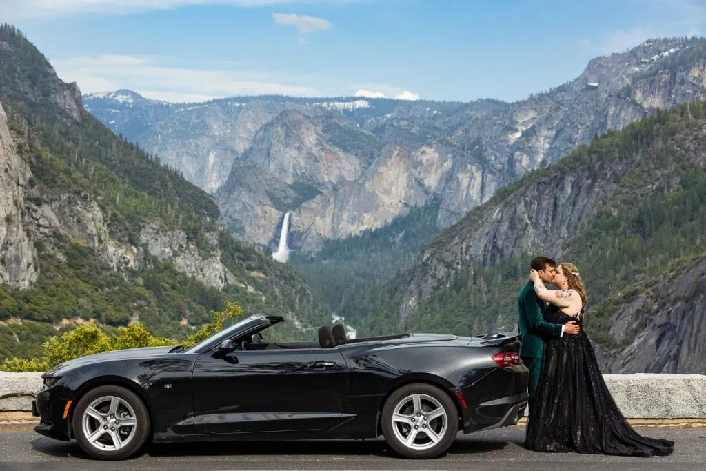 A yosemite elopement couple poses for photos with their black camaro in Yosemite national park.