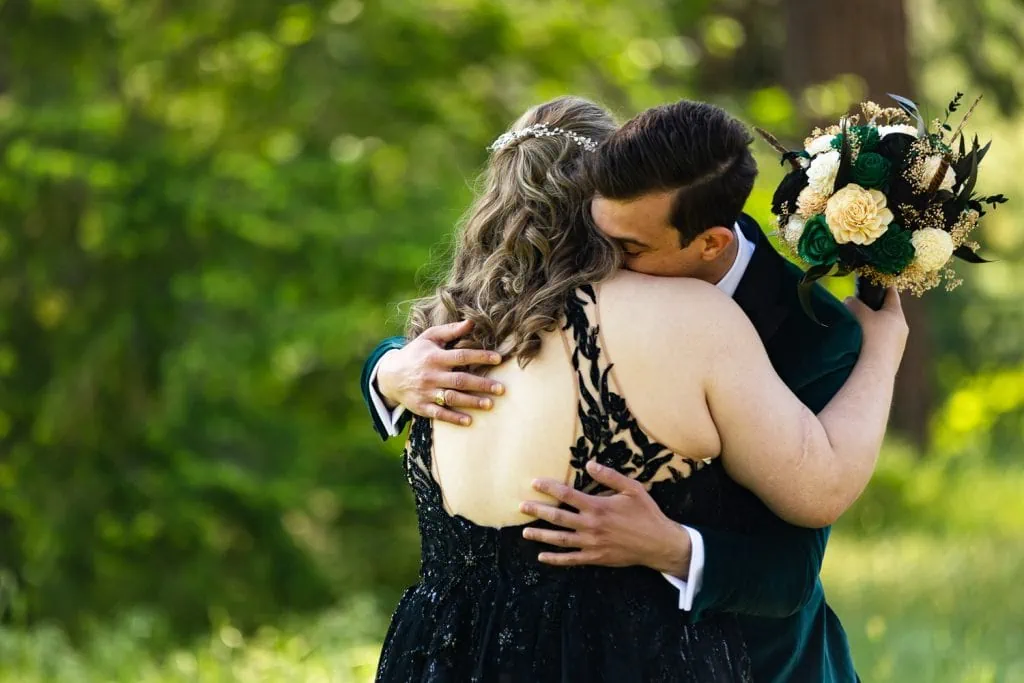 The groom embraces the bride in this candid photo at their yosemite elopement.