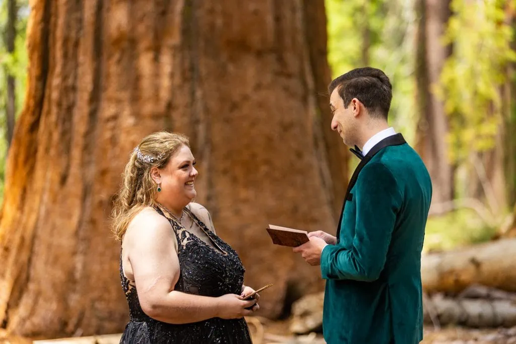 The elopement couple laughs together during their yosemite elopement ceremony in the forest.