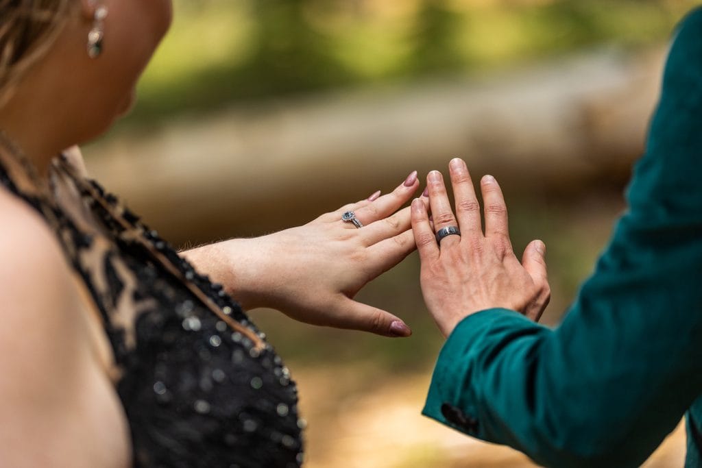 The newlyweds admire their rings together in this yosemite elopement photo.