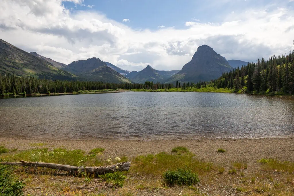 The shore of Pray lake in the Two Medicine region of Glacier National Park is surrounded by mountains and nature.
