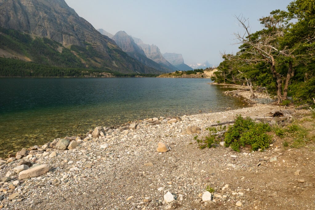 The shoreline of Lake Mary at Rising Sun is a beautiful elopement ceremony location in Glacier National Park.