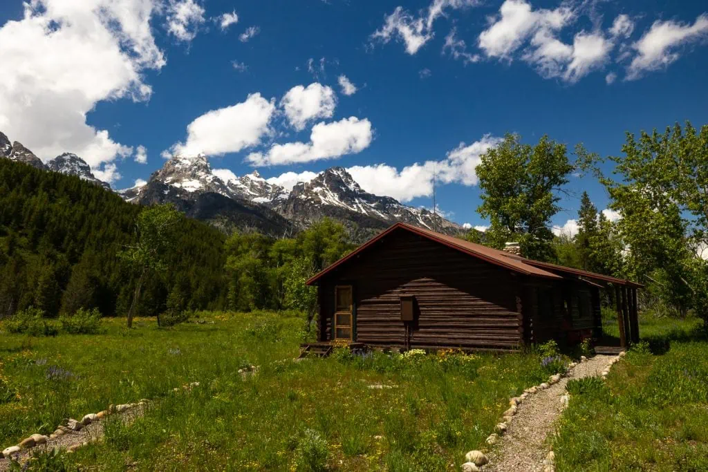The climbers ranch cabin inside Grand Tetons National Park is pictured here against the backdrop of the huge mountains.