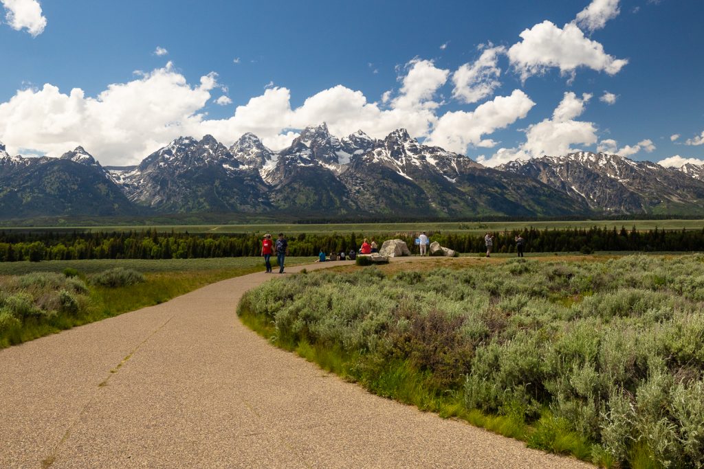 A paved path leads to the Glacier View turnout elopement location overlooking Grand Tetons National Park.