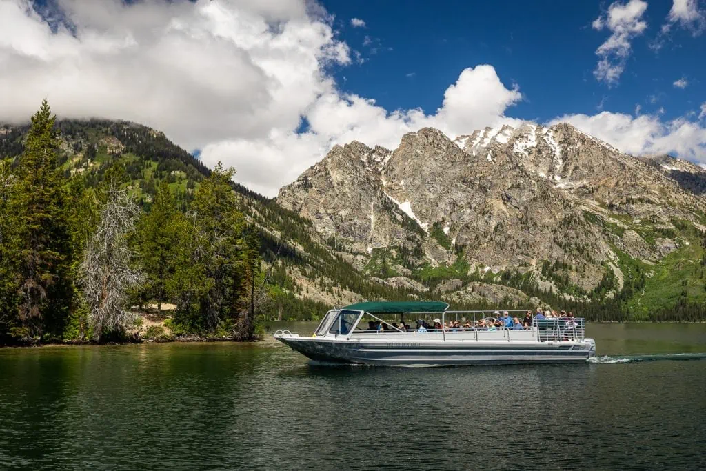 A boat that offers scenic tours of Jenny Lake is shown here against the mountain backdrop.