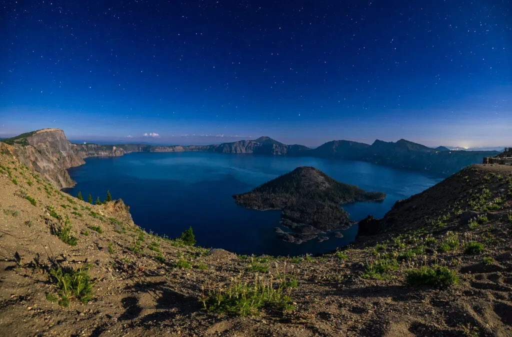 A nighttime photograph of the stars above Crater Lake National Park in summer.
