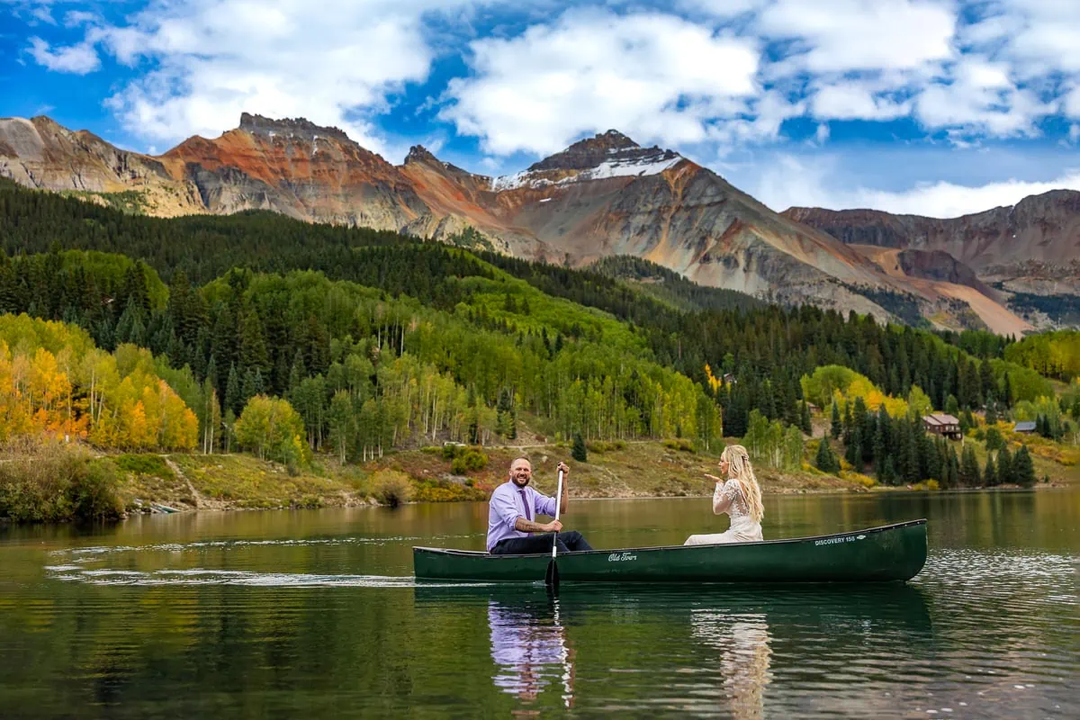 A couple eloping in telluride take a canoe out on Trout Lake in september.
